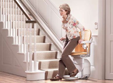 woman getting off a stairlift